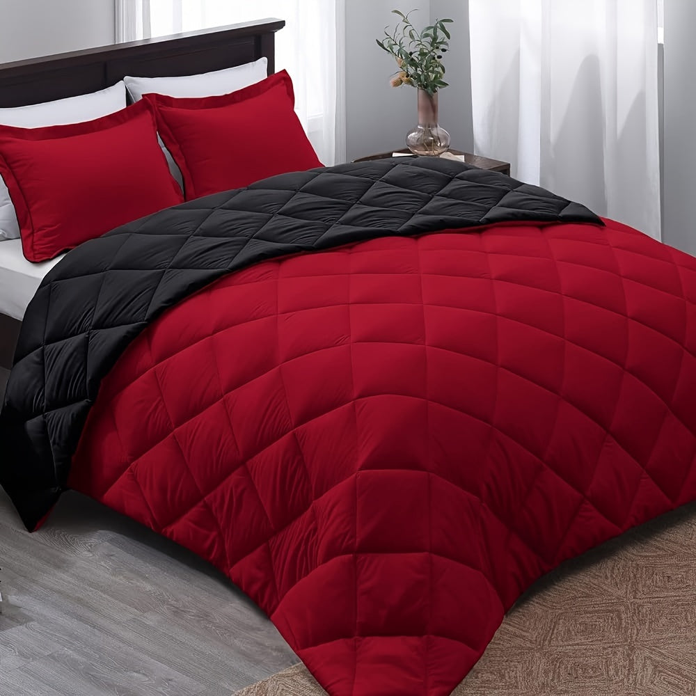 Red and black quilted comforter set on a bed in a bedroom.