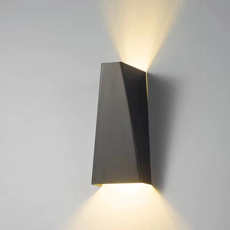 Modern wall-mounted light fixture on a gray wall