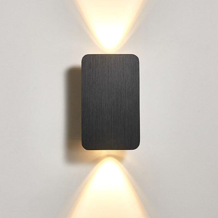 Modern wall-mounted light fixture on a plain background
