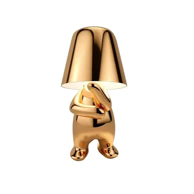 Gold-colored lamp with a unique design on a white background