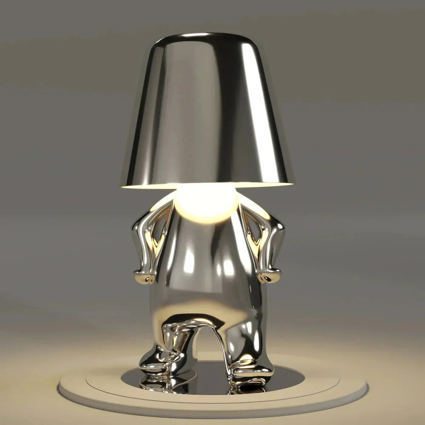Metallic elephant-shaped lamp on a gray background