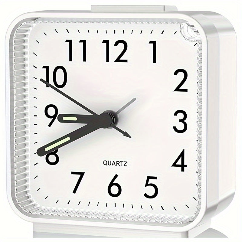 White alarm clock with black numbers and hands on a white background