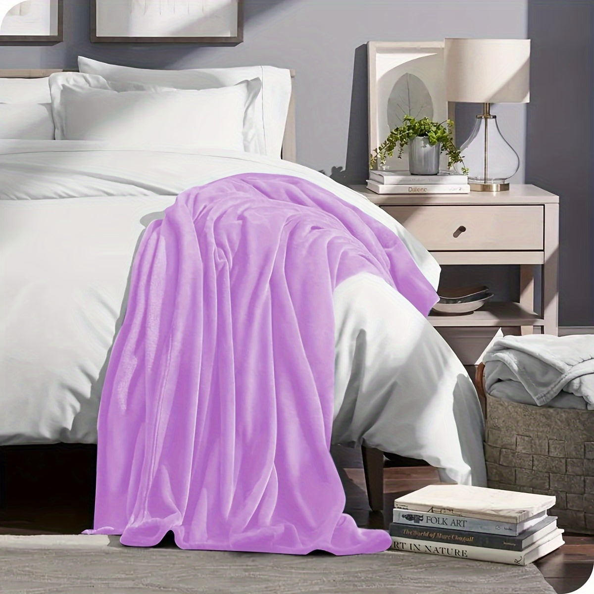 Purple blanket draped over a bed in a bedroom setting with a nightstand and lamp.