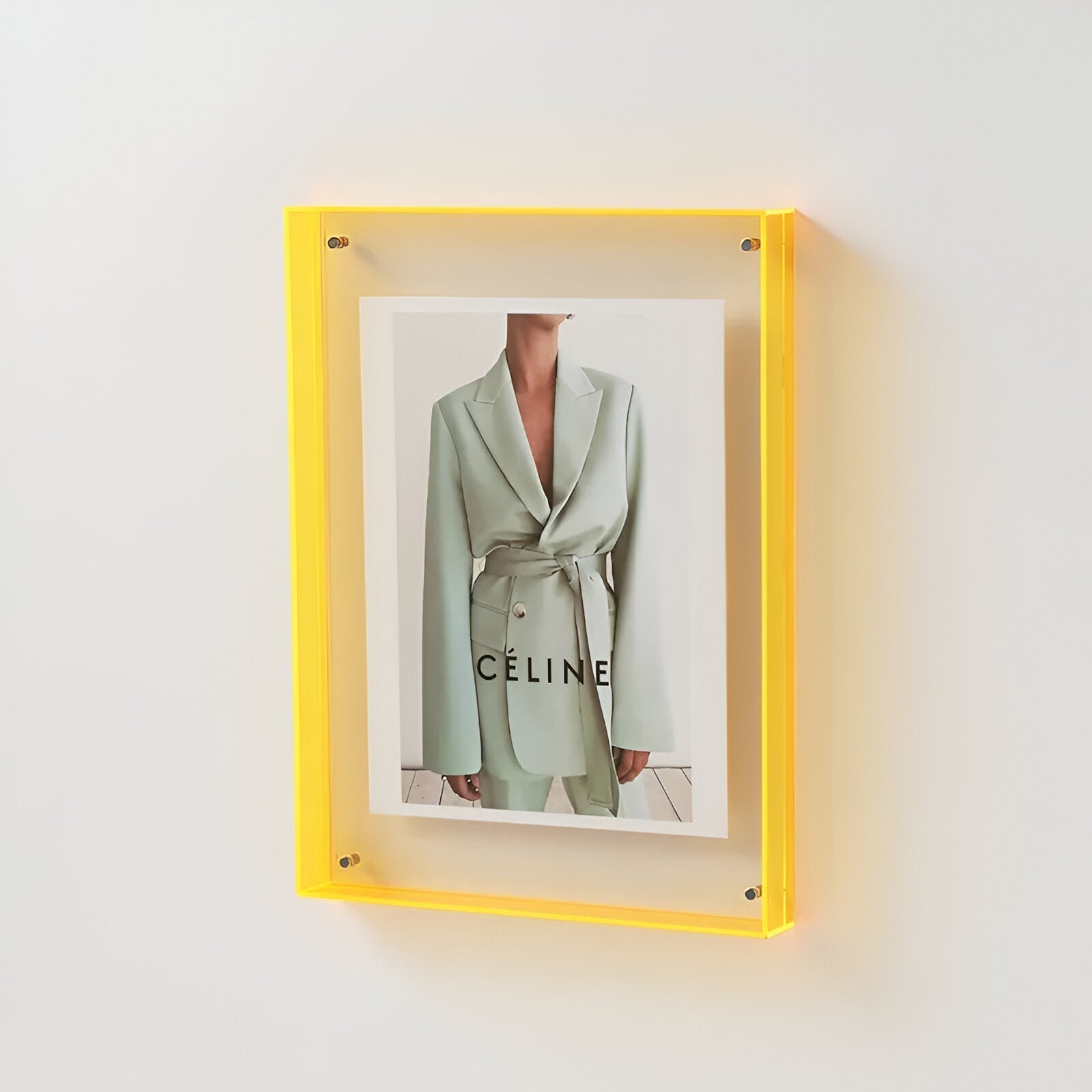 Yellow-framed Celine advertisement on a white wall