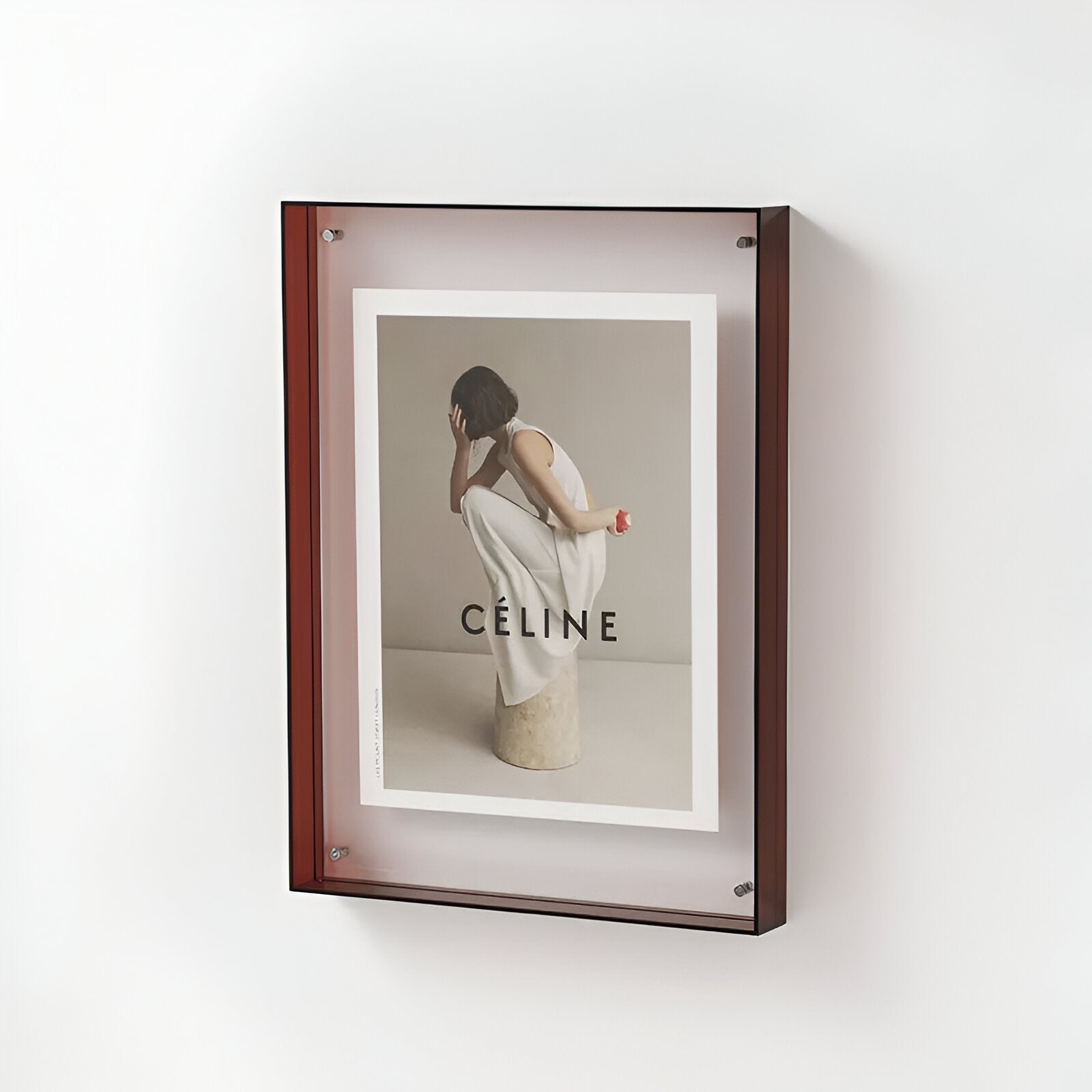 Framed Céline advertisement on a white wall