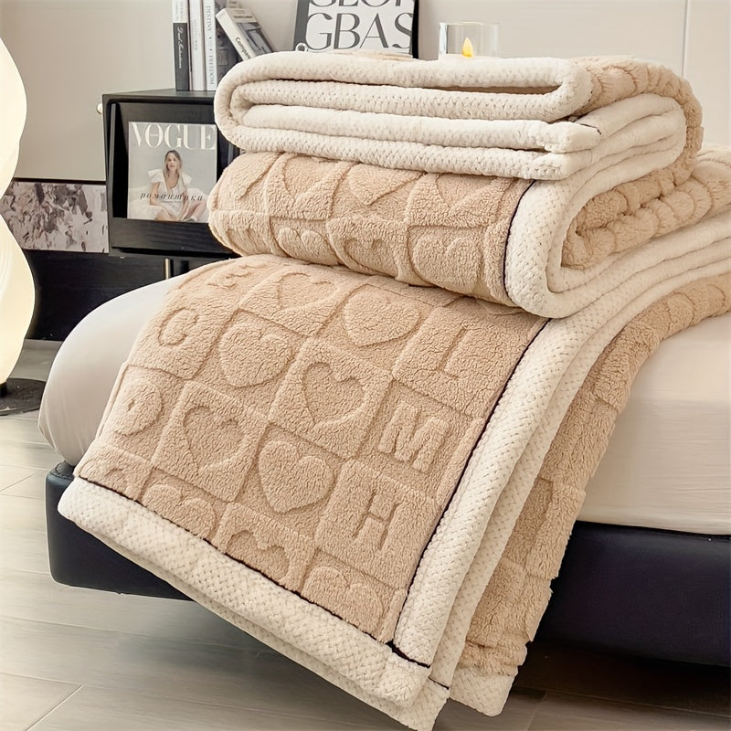 Beige textured blanket draped over a bed in a bedroom setting.
