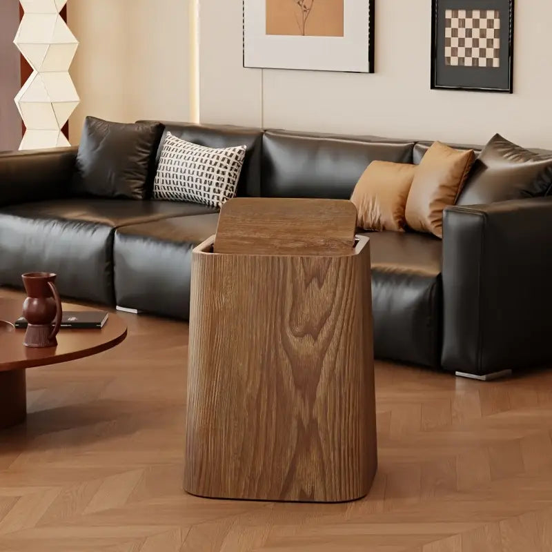 Wooden side table in a living room with a sectional sofa and decorative pillows.