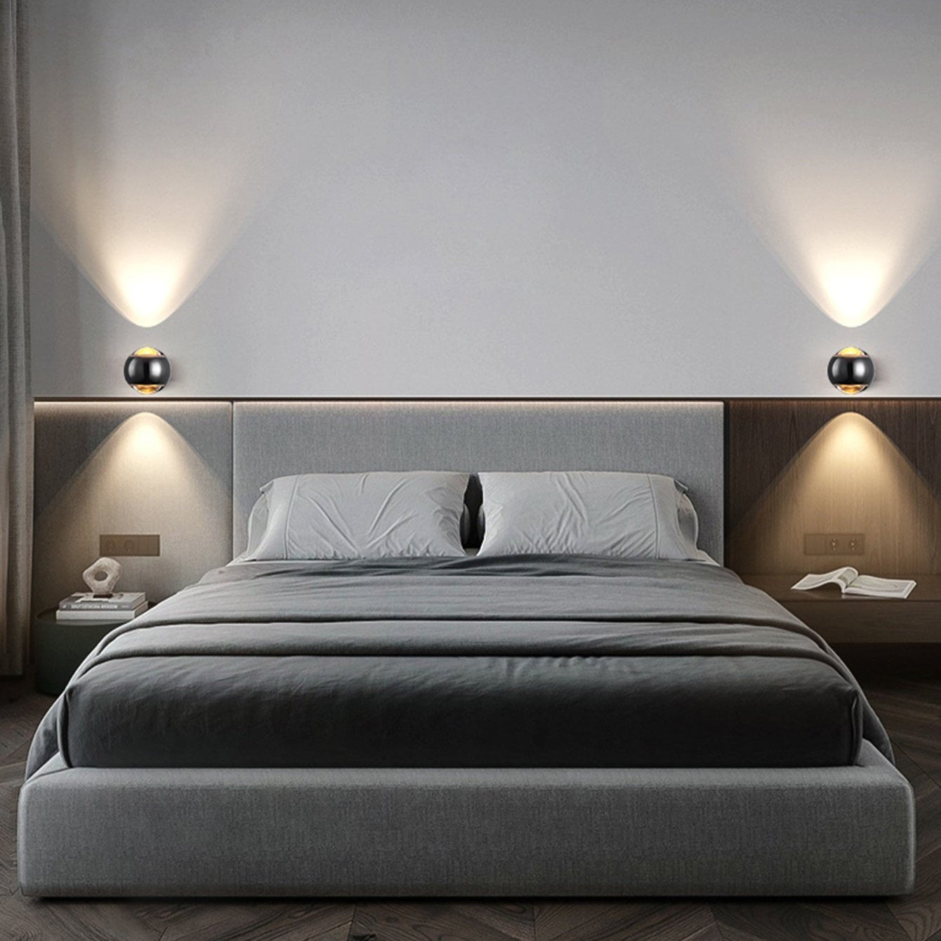 Modern bedroom with a gray bed and wall lights.