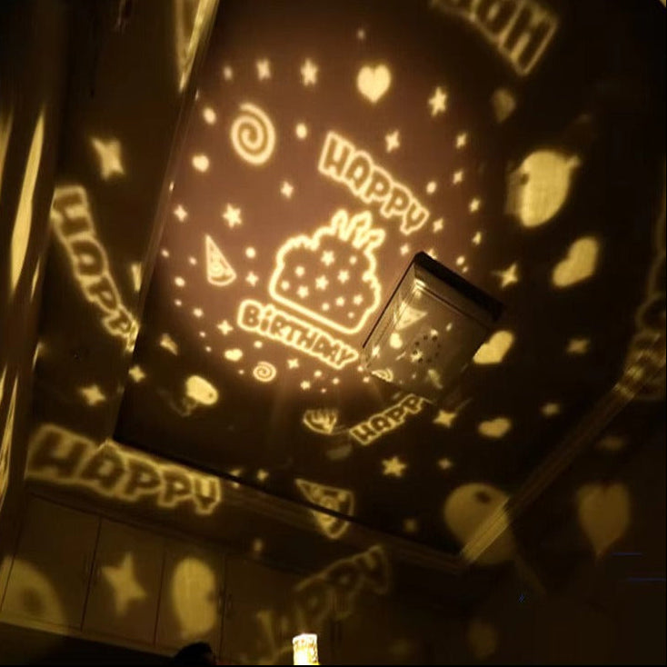 Light-up projector with 'Happy Birthday' and cake design on a dark background