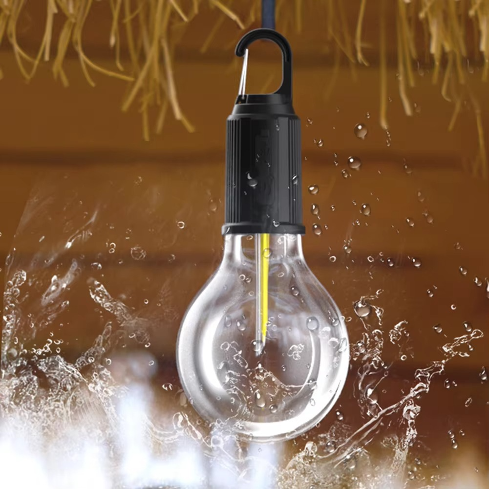 Light bulb with water droplets against a blurred background