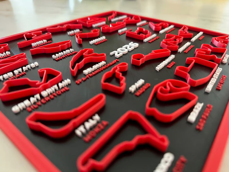 Red and white dental model on a black tray with visible text