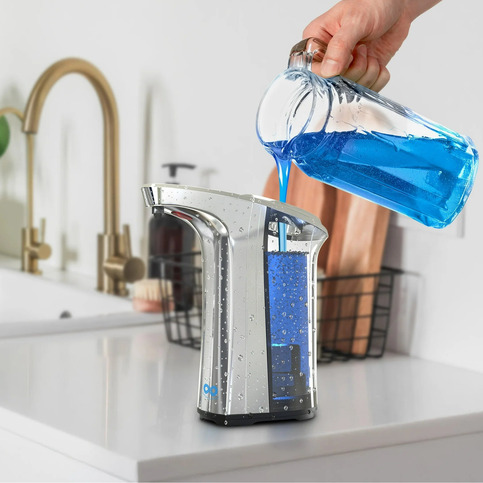 Hand pouring blue liquid from a bottle into a silver soap dispenser with text 'Easy Refill 500ml Capacity' on a kitchen counter.
