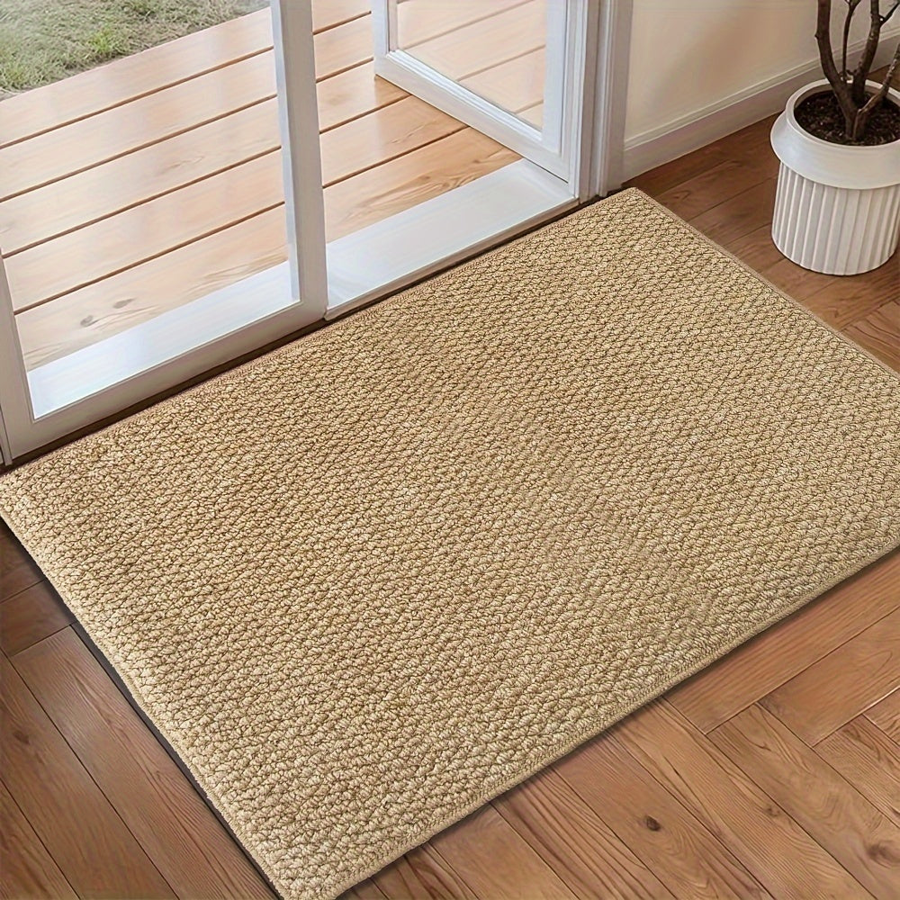 Beige doormat on a wooden floor in front of a glass door.