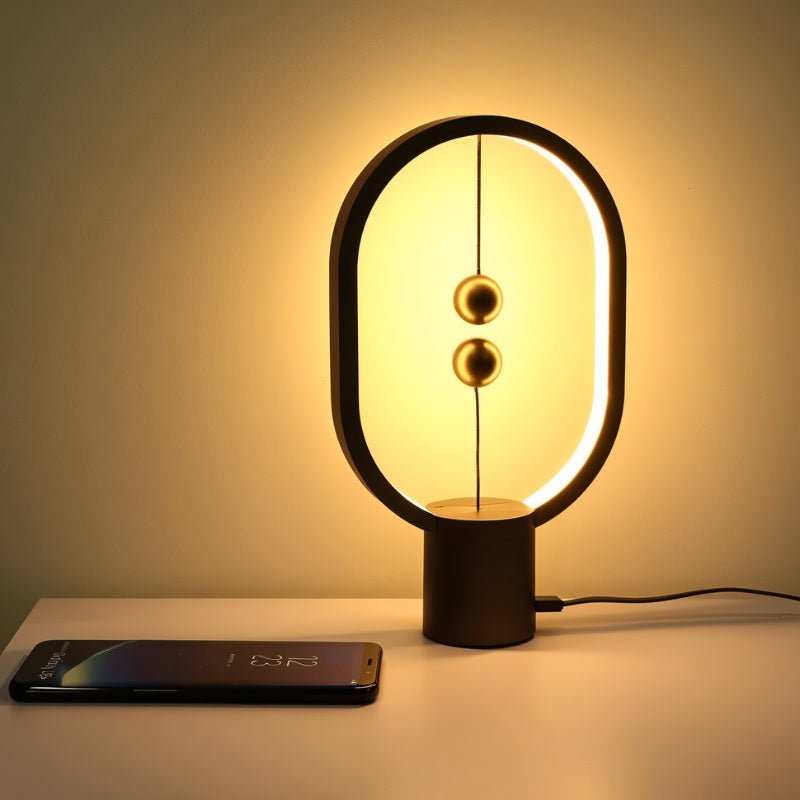Modern table lamp with a smartphone on a white surface