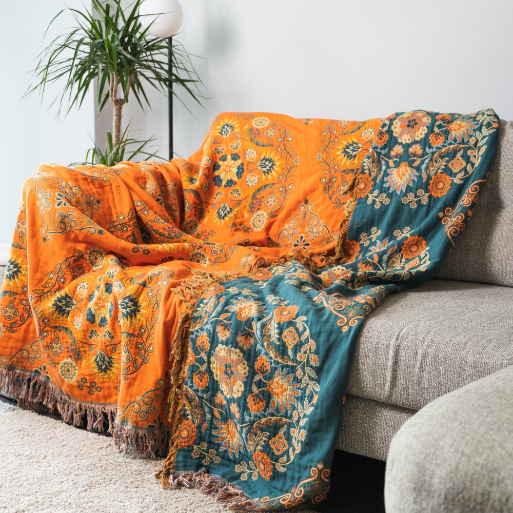 Floral patterned blanket draped over a sofa in a living room setting