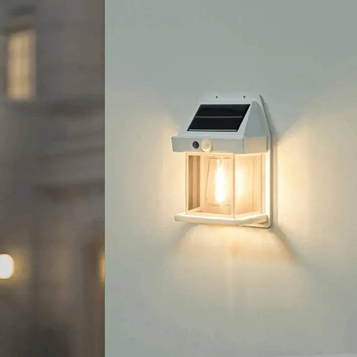 Solar-powered outdoor wall light fixture on a wall with a blurred background