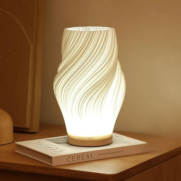 Decorative lamp with wavy design on a wooden surface