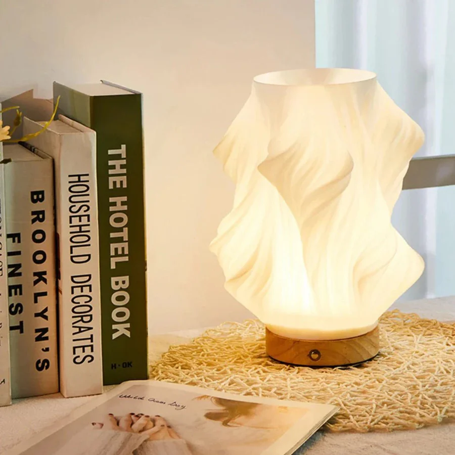 Decorative lamp on a table with books and a magazine