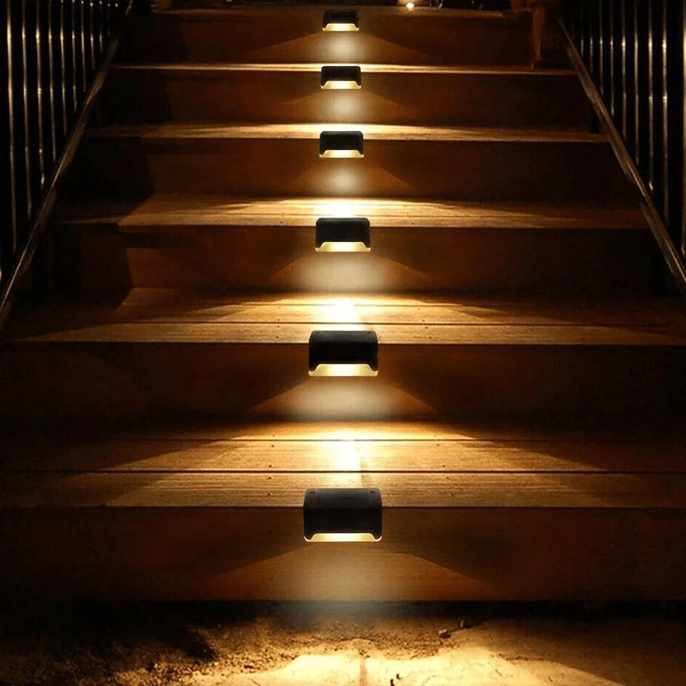 Wooden stairs with embedded lights illuminating the steps in a dark setting
