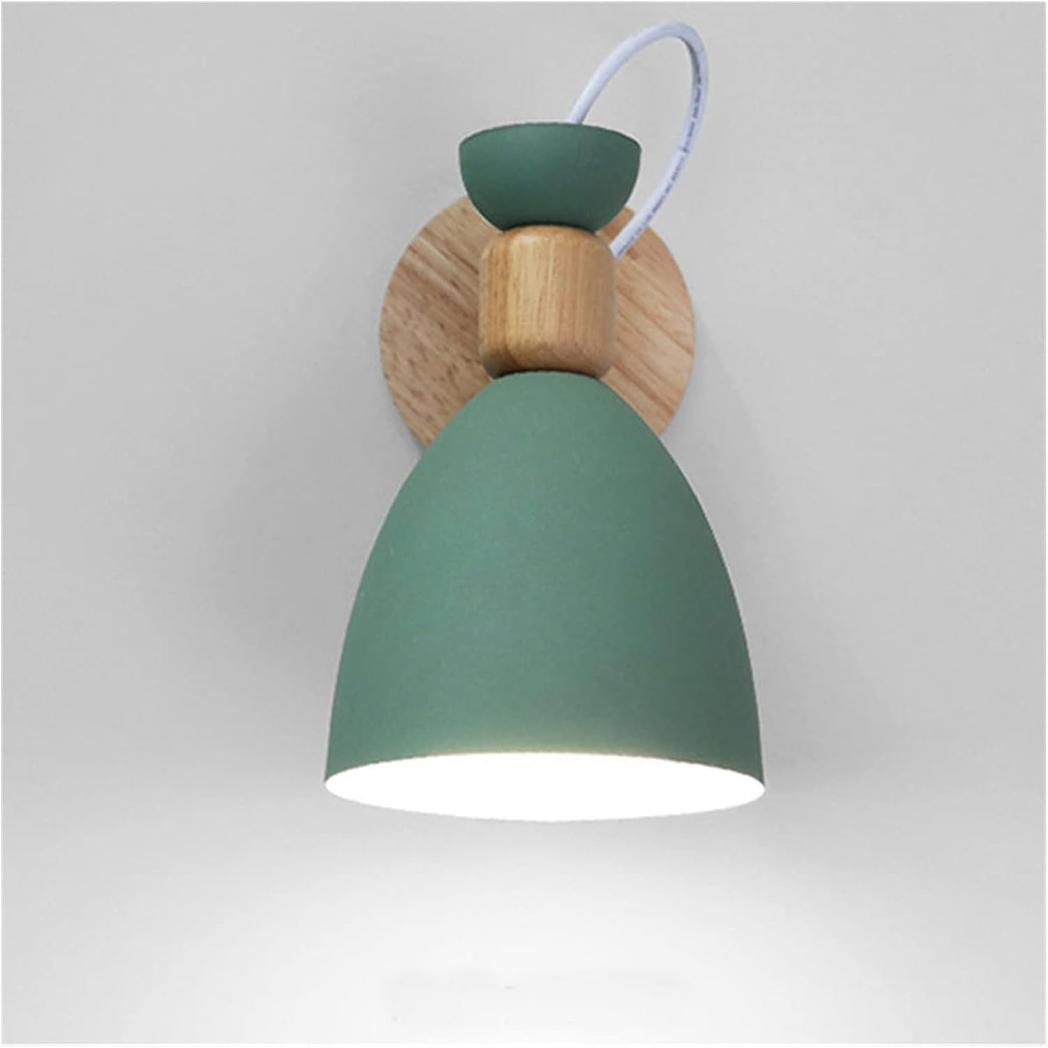 Green wall light fixture with wooden base on a gray background
