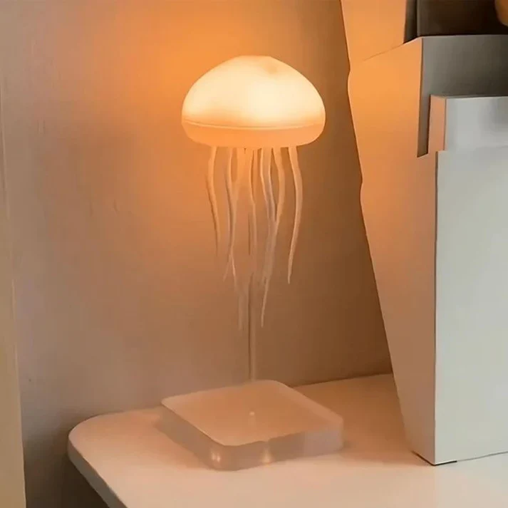 Jellyfish-shaped lamp on a white surface with a neutral background