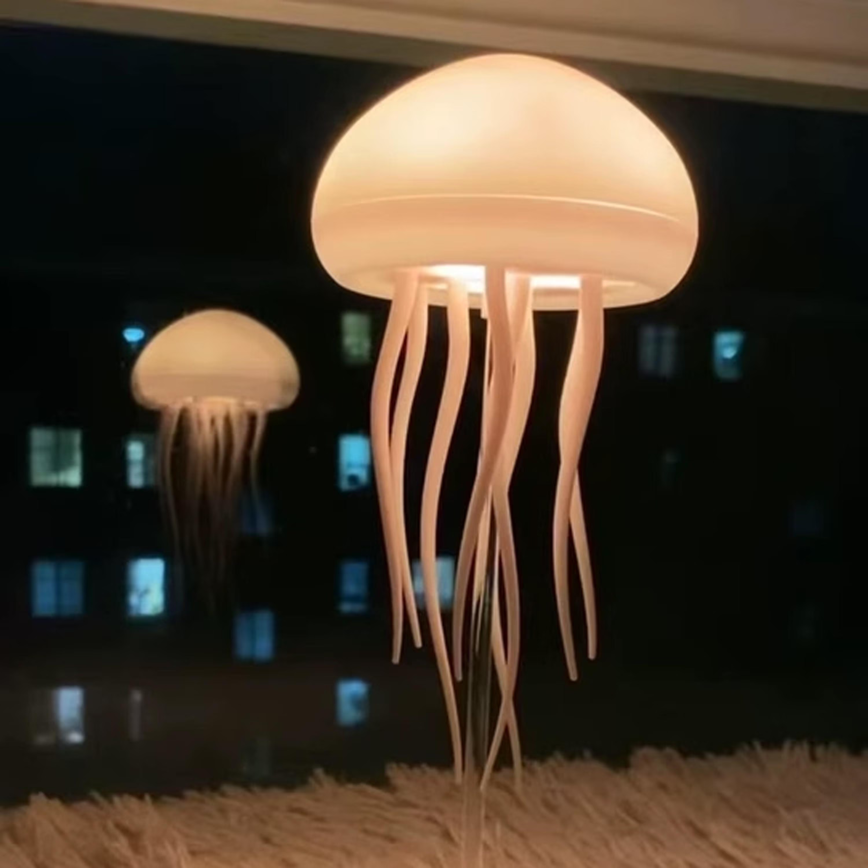 Two jellyfish-shaped lamps on a dark background