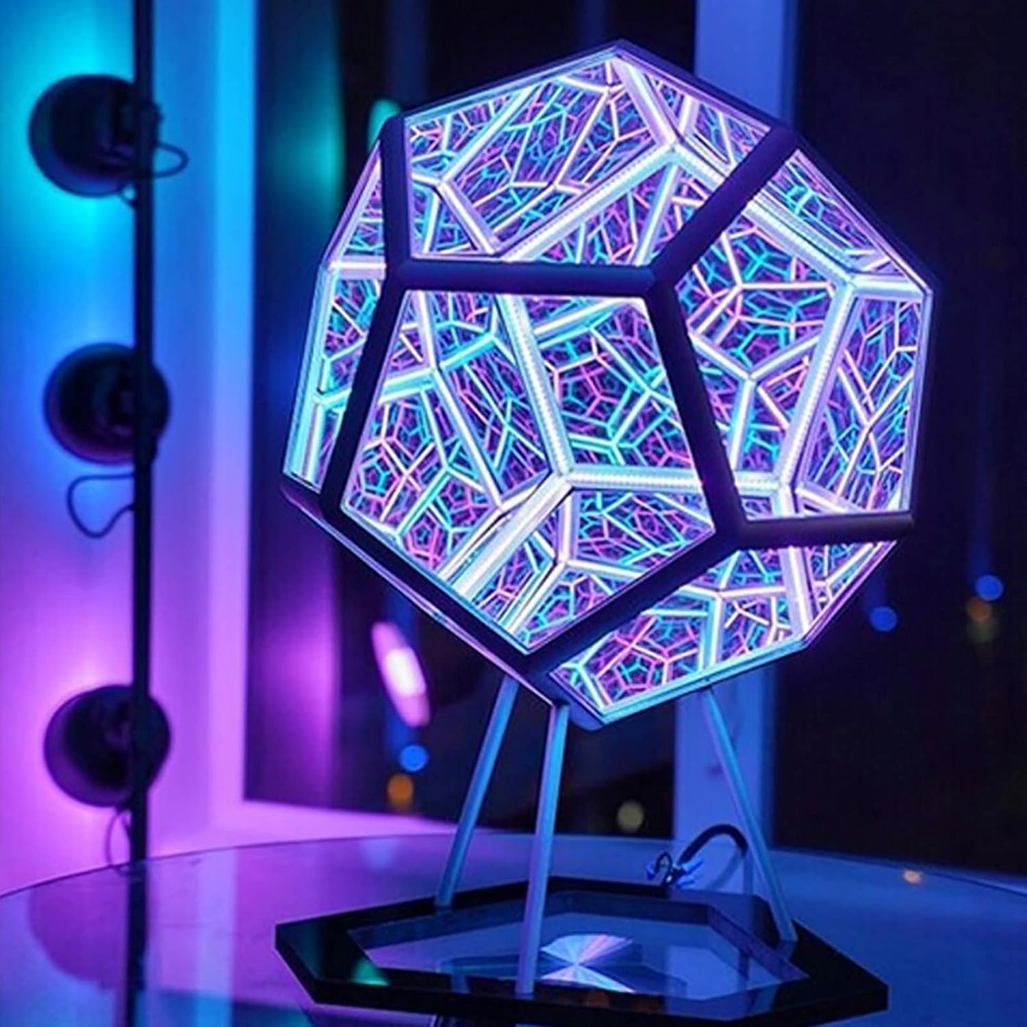 Geometric lamp with colorful design on a stand against a dark background