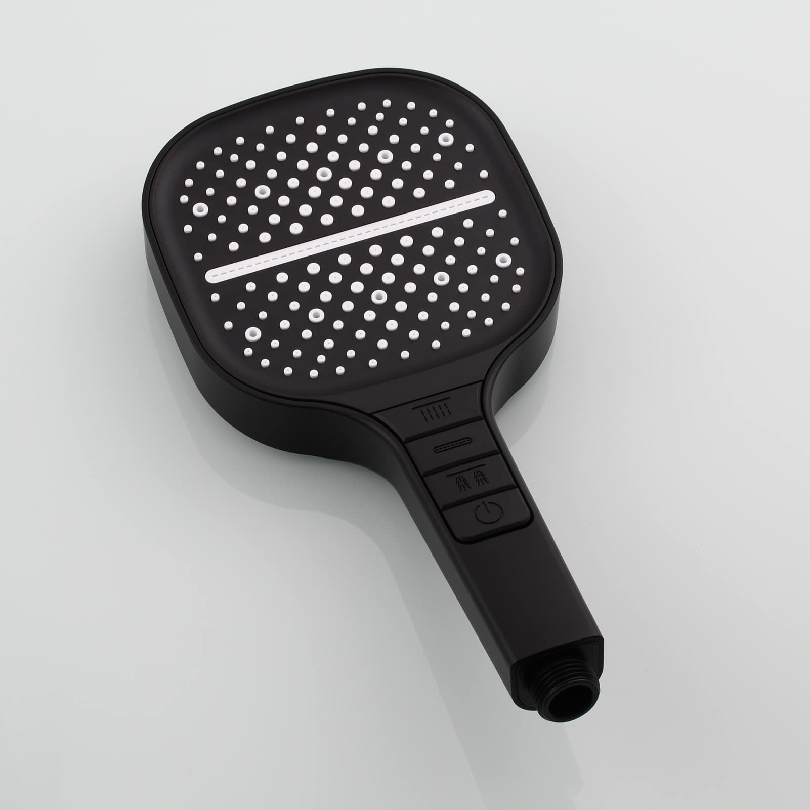 Black paddle with textured surface on a light gray background