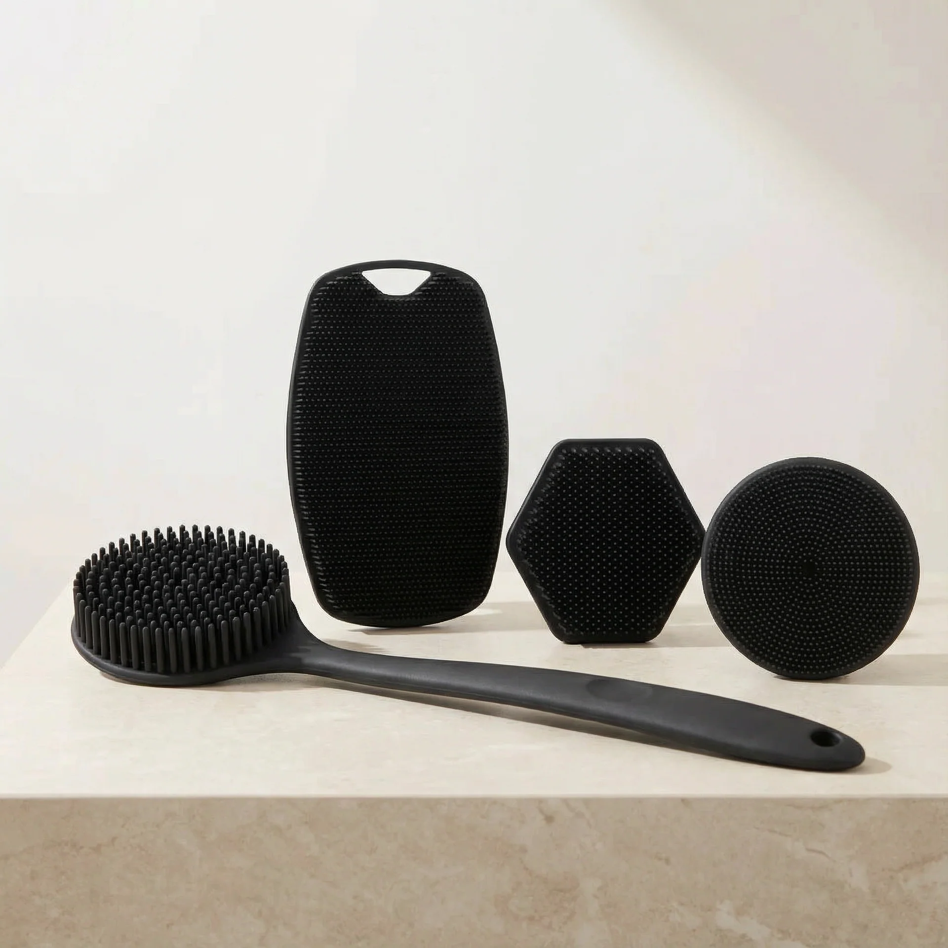 Set of black skin-friendly brushes on a light surface with a neutral background