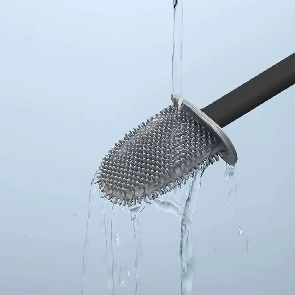 Shower head with a textured head and water flowing from it against a light blue background