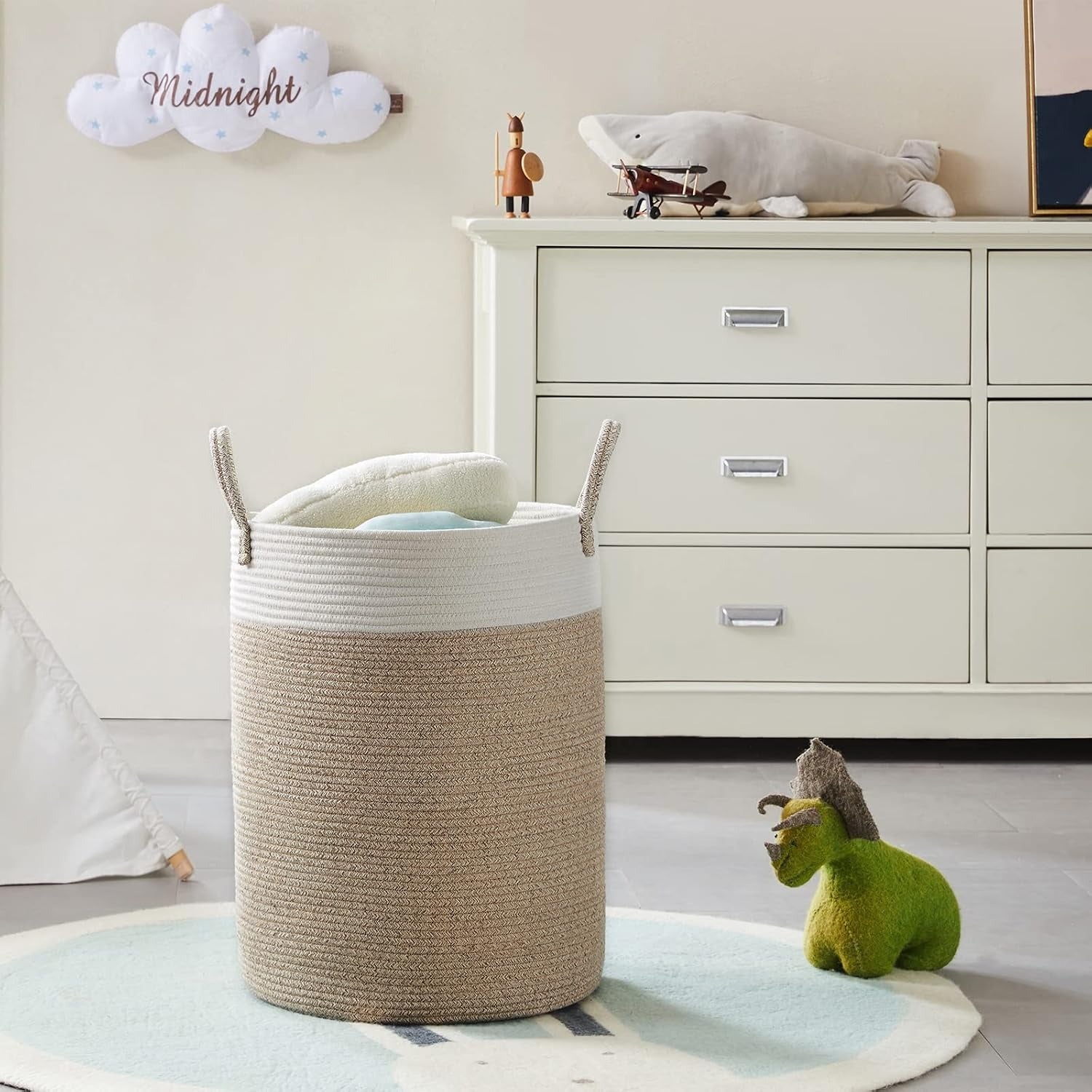 Beige and white woven laundry basket in a room with a dresser and toys.