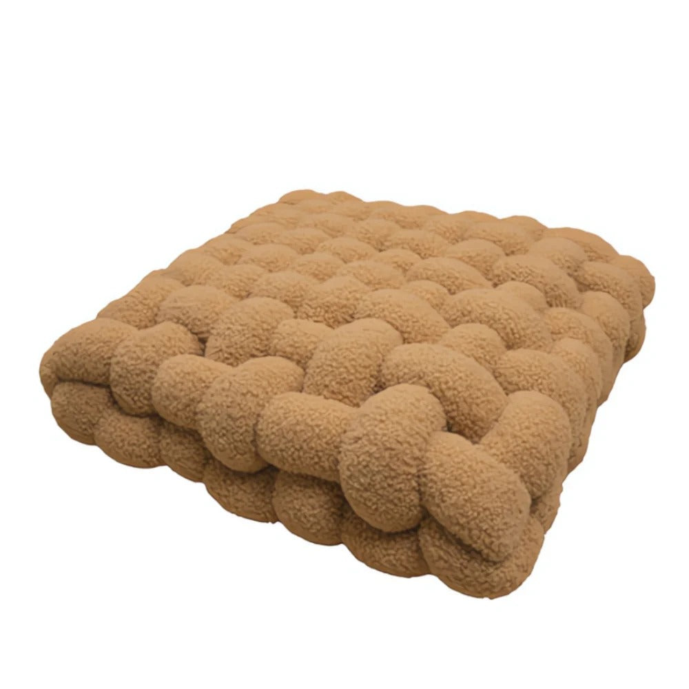 Brown textured cushion on a white background