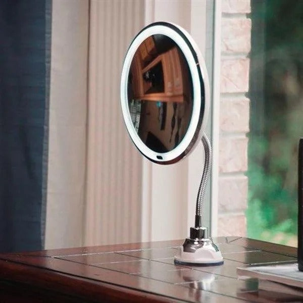 Round makeup mirror with LED lights on a wooden surface