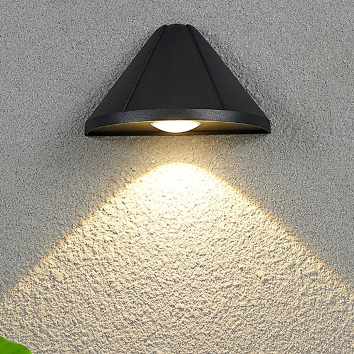 Black outdoor wall light fixture on a textured gray wall