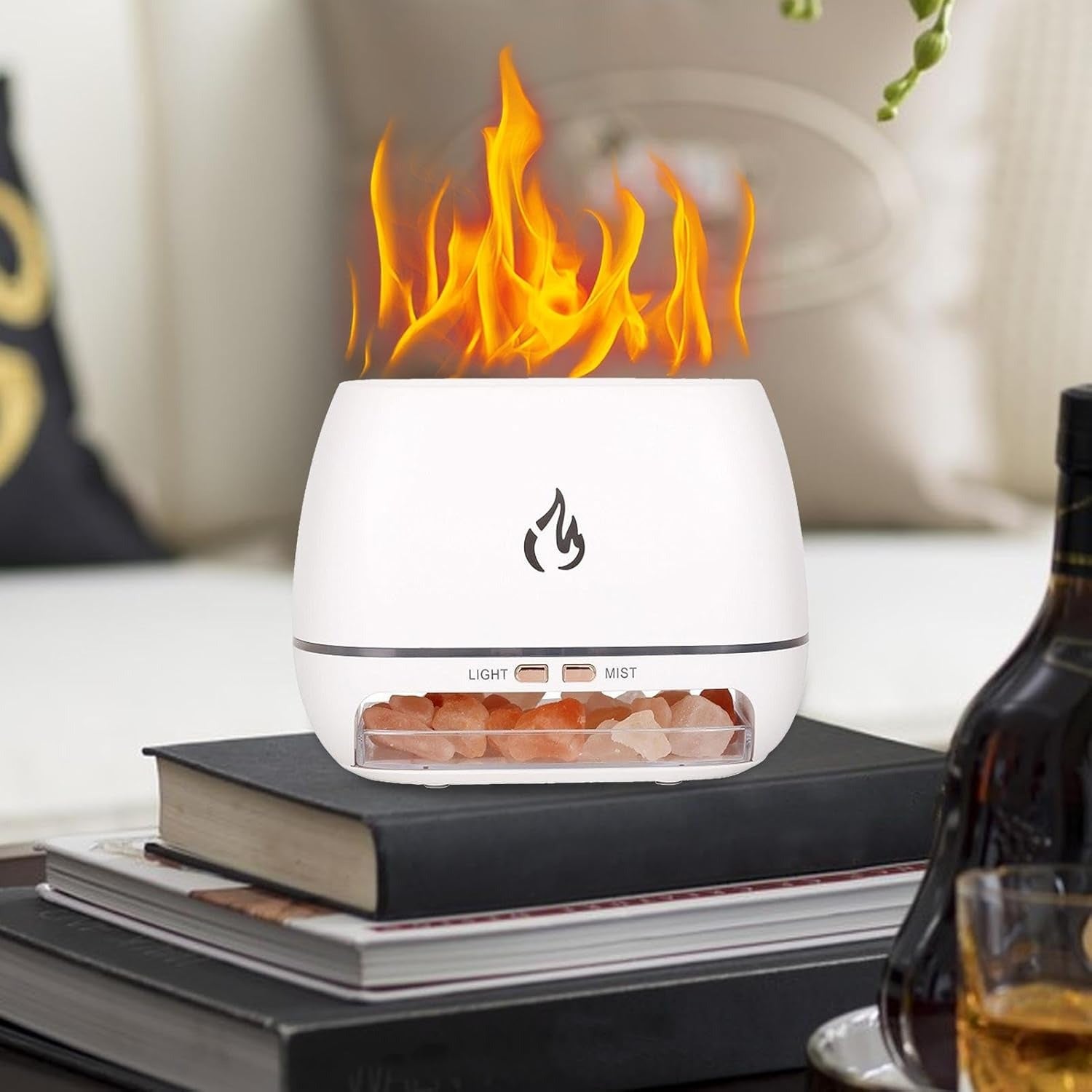 White flame-shaped diffuser on books with a blurred background