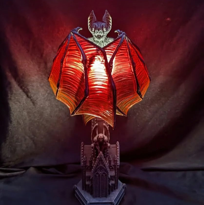 Lamp with bat design on a dark background