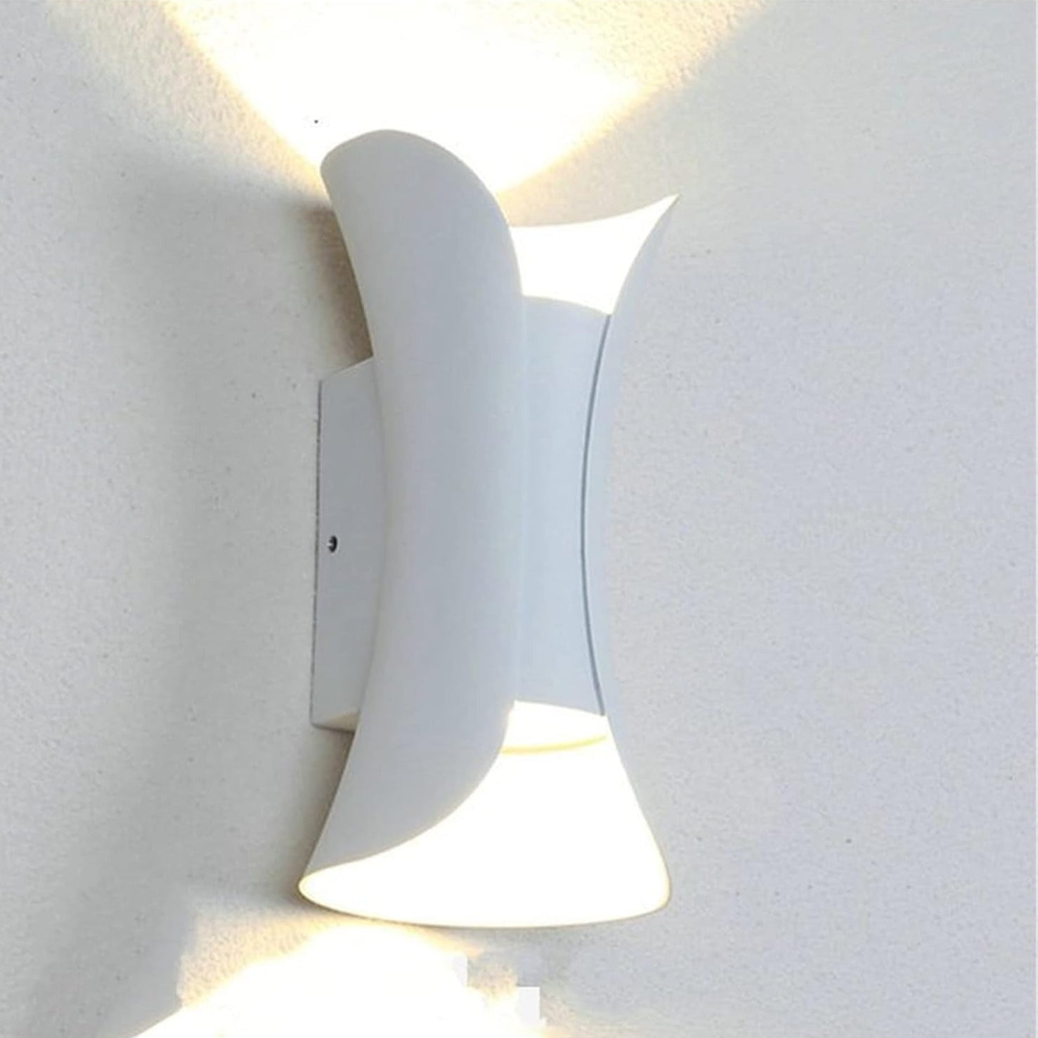 Modern wall-mounted light fixture on a white wall