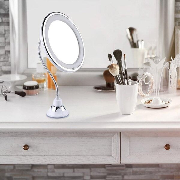Makeup mirror with light on a vanity table with various makeup items.