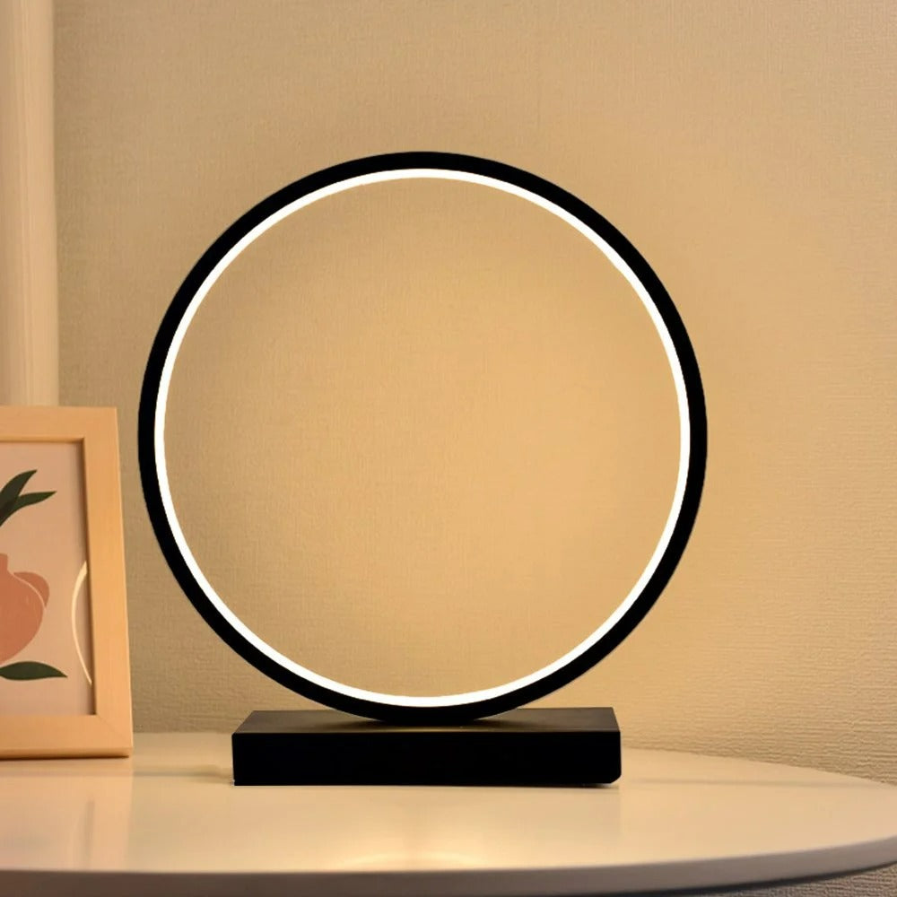 Modern circular table lamp with a black base on a neutral background