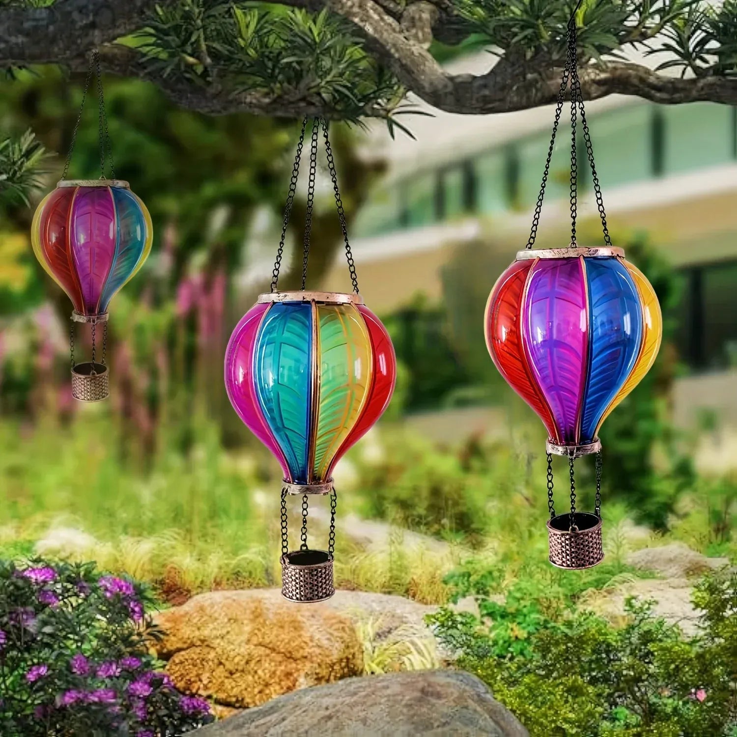 Colorful hot air balloon-shaped solar lights hanging outdoors.