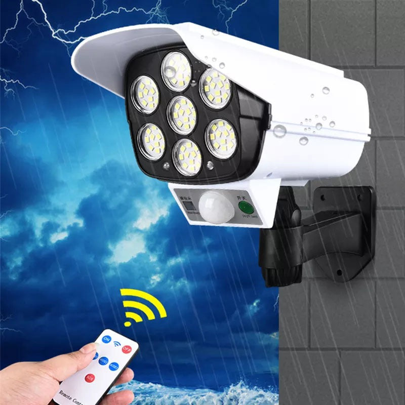 Security camera with remote control on a background of stormy weather and tiled floor.
