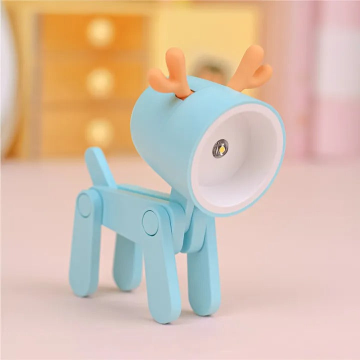 Blue deer-shaped night light on a soft pink background
