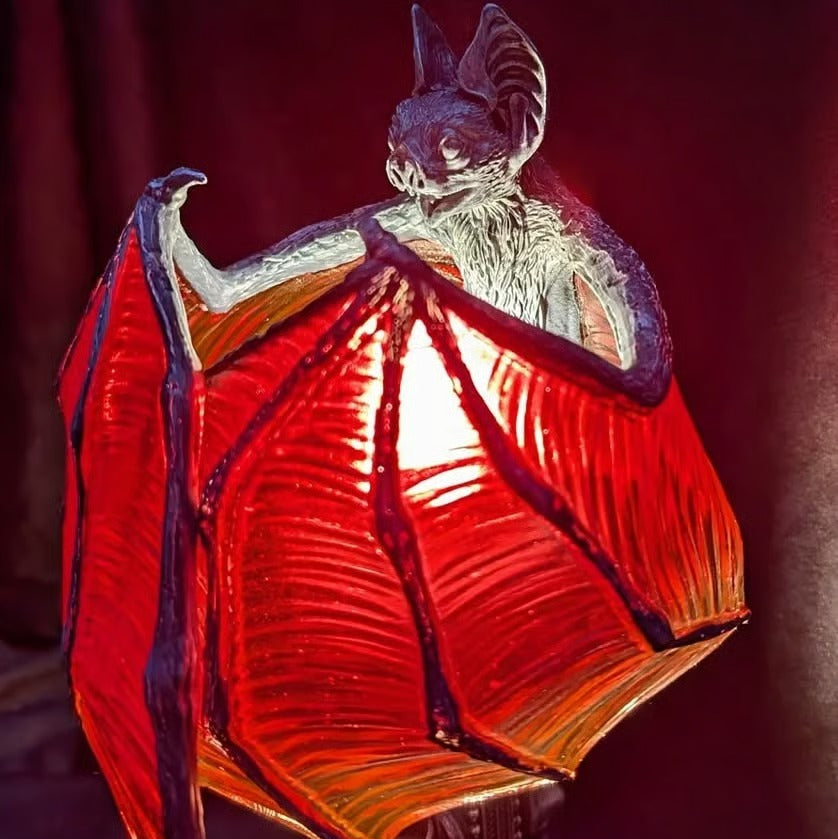Decorative bat lamp with glowing red wings design