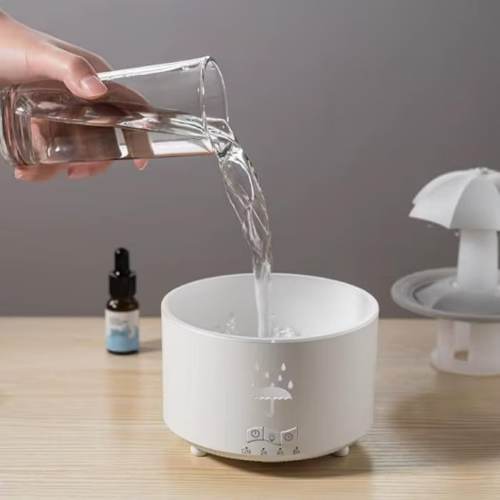 Person pouring water into a white diffuser on a wooden surface with a gray background