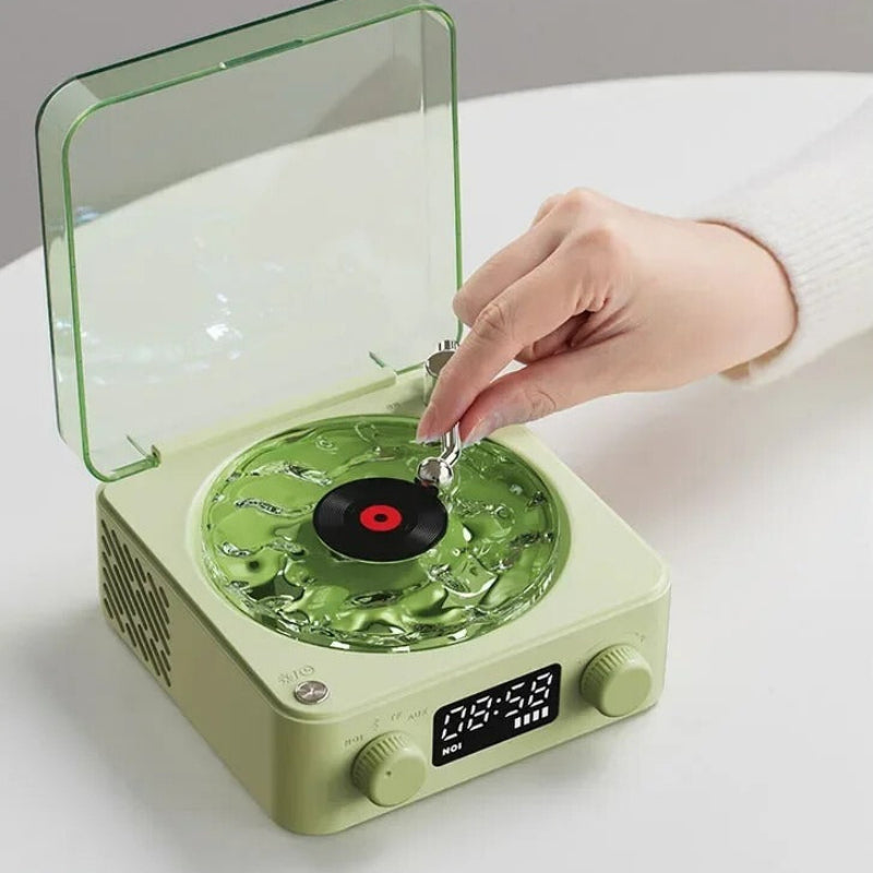 Green record player with a hand placing a vinyl record on it, surrounded by images of nature-themed records.