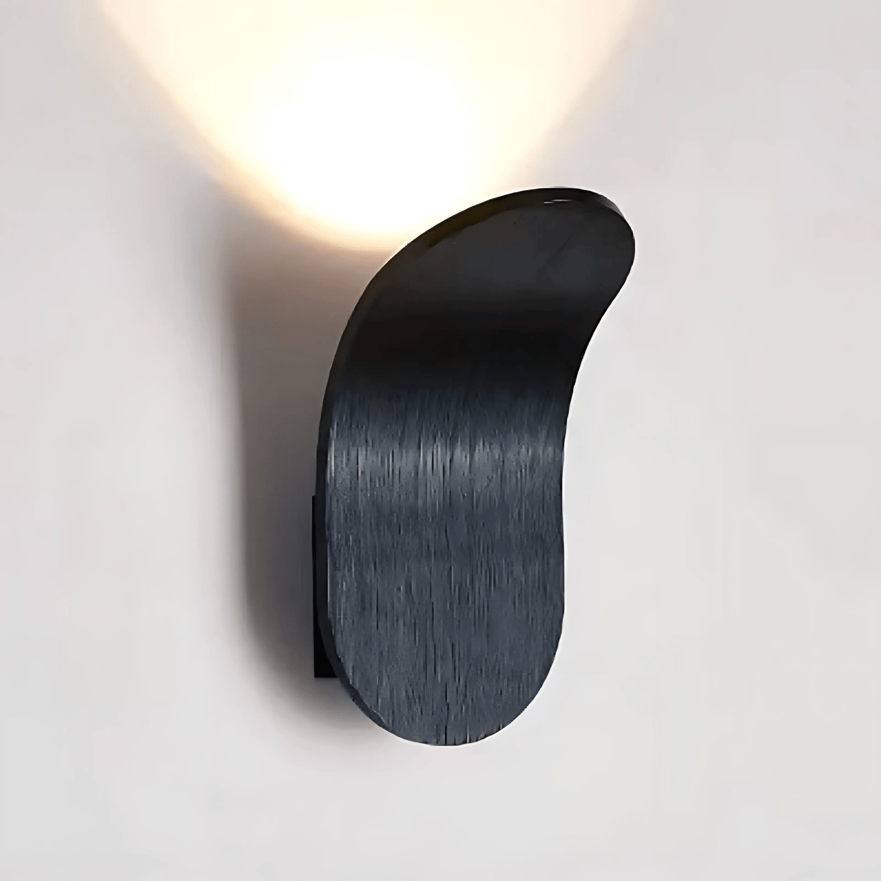 Modern black wall light fixture on a gray background