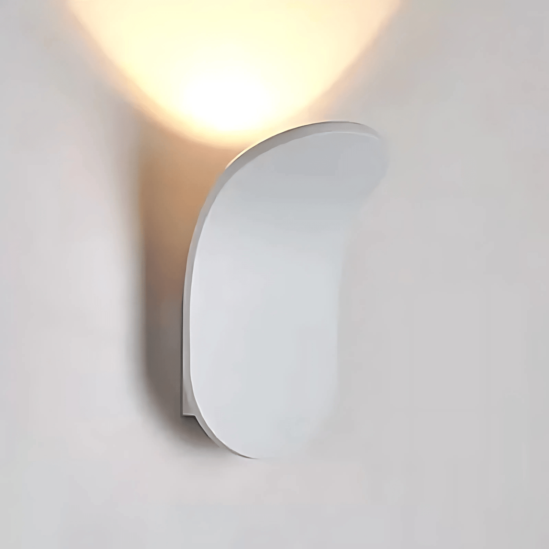 Round wall light fixture on a plain white wall