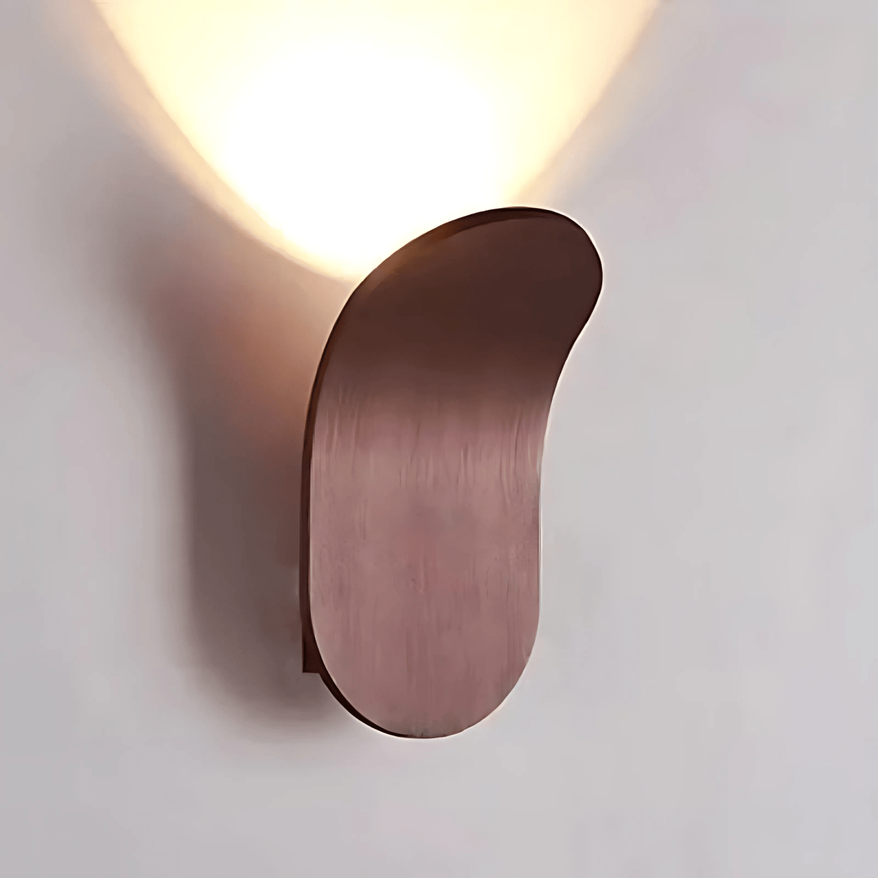 Modern wall sconce with a warm light on a neutral background