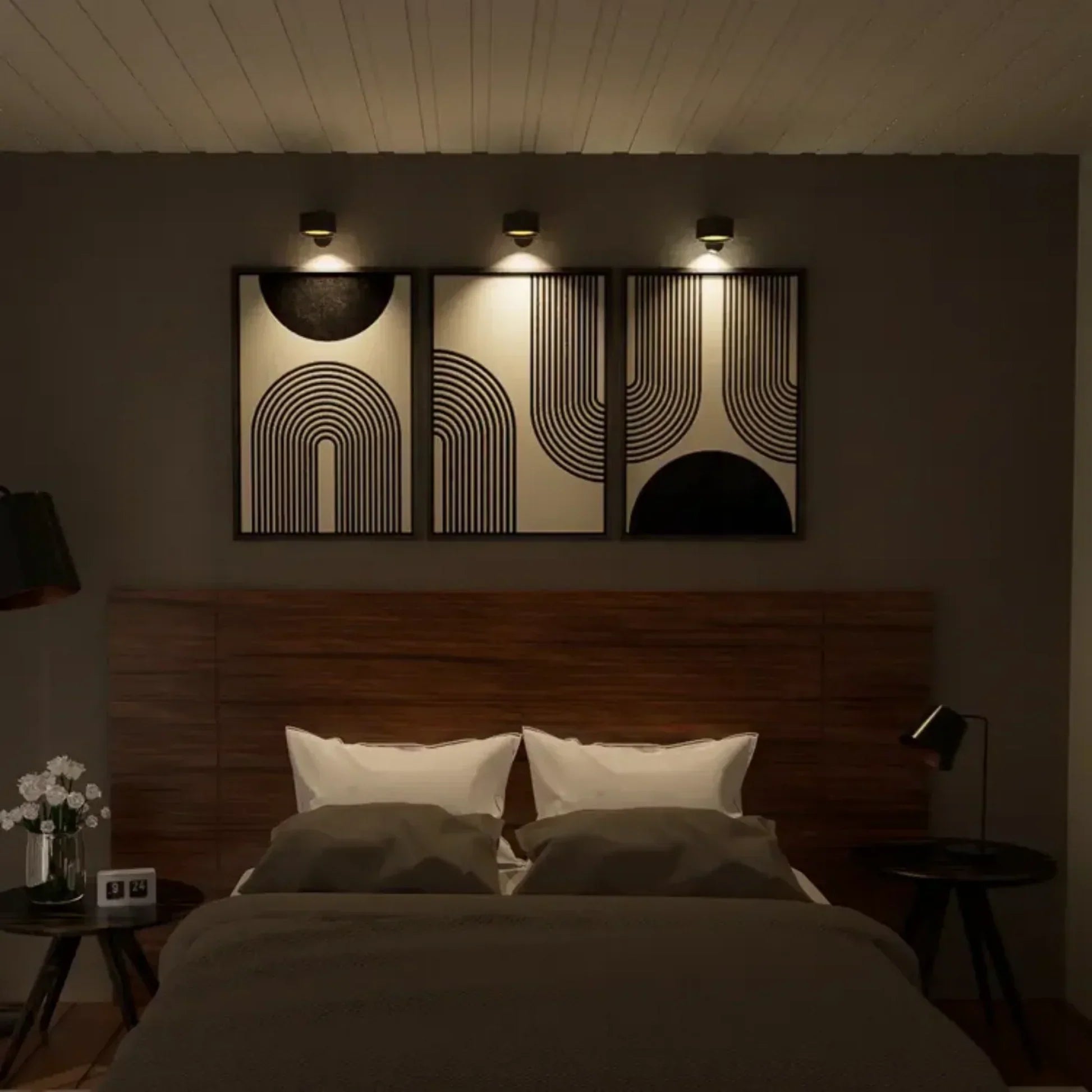 Dark bedroom with a bed, nightstands, and wall art