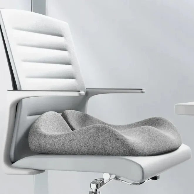 Gray cushion on a white chair with a blurred background